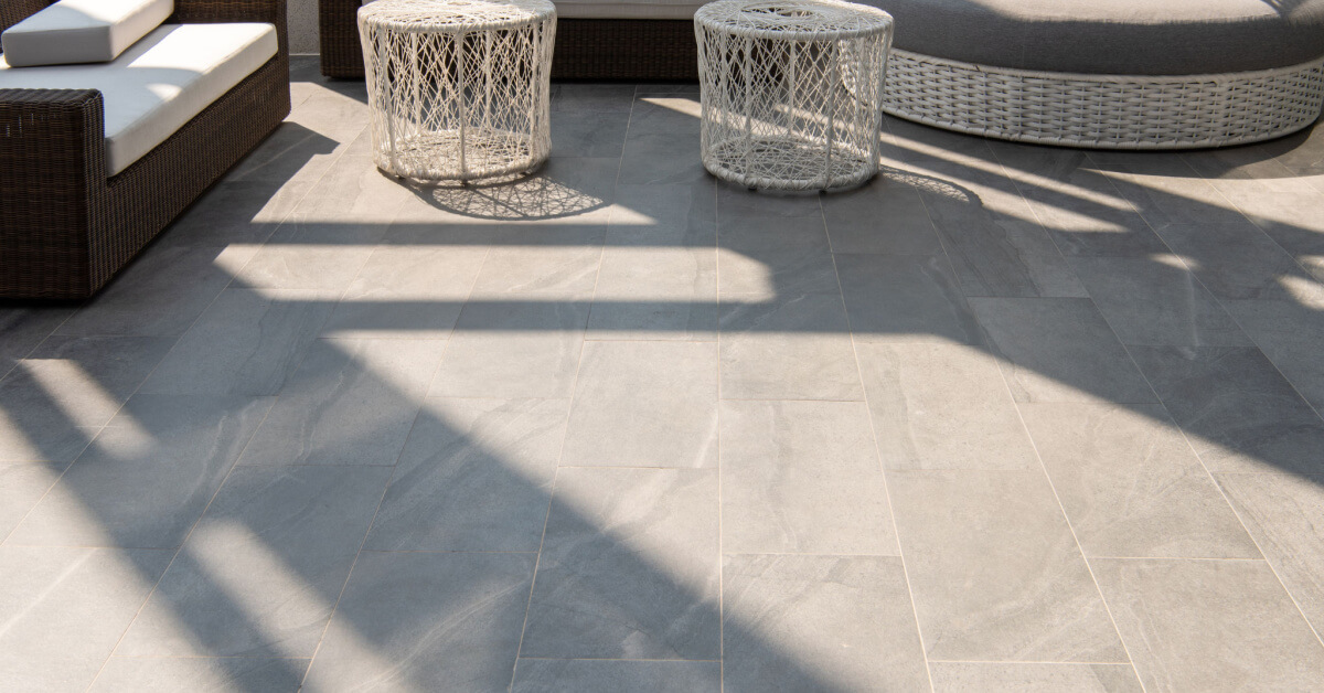 Outdoor terrace area with grey floor tile with sitting area